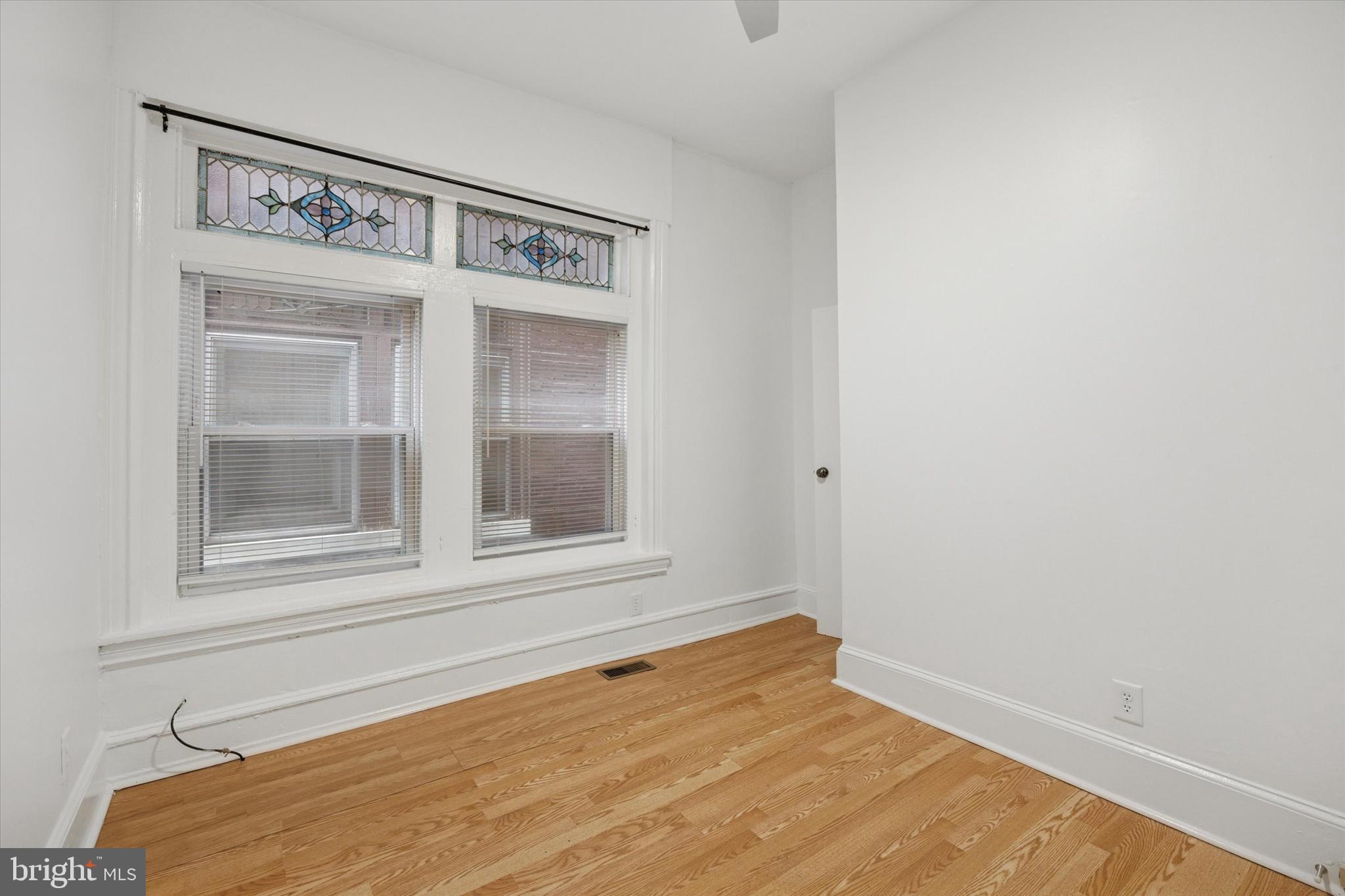 236 Buckingham Place Philadelphia, PA 19104 - Photo 7 of 11 a view of an empty room with wooden floor and a window