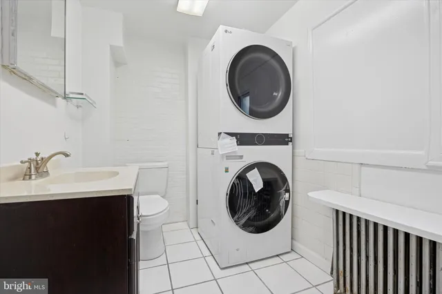a utility room with sink dryer and washer