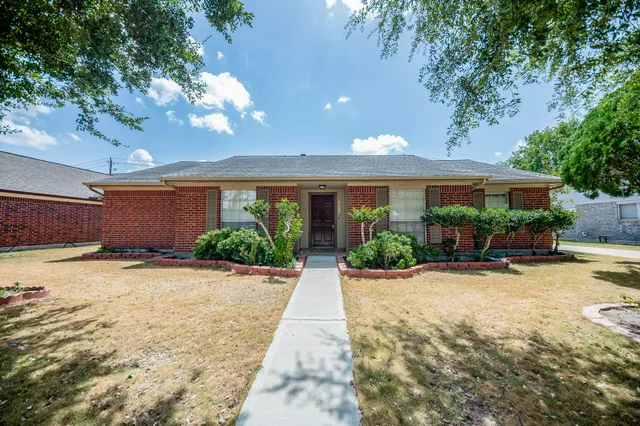 a view of a house with palm trees
