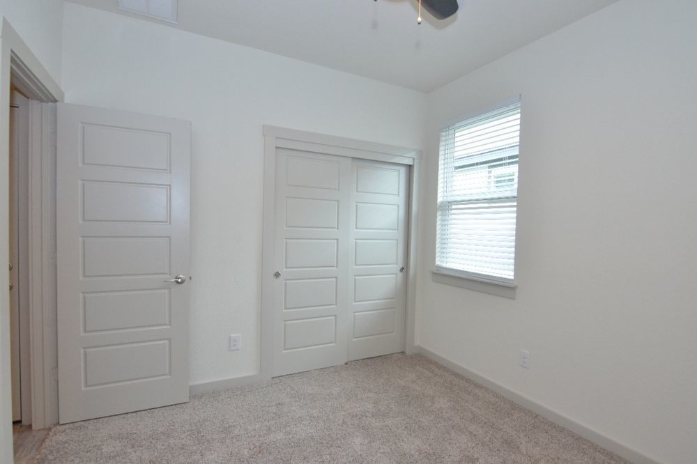 428 Agave Azul Way Leander, TX 78641 - Photo 17 of 24 Plush carpeting and five-panel interior doors define this comfortable bedroom space.