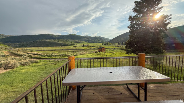 143 East Chestnut Street Helper, UT 84526 - Photo 17 of 35 Deck with a view of rural / pastoral area, a mountain view, a lawn, and outdoor dining area