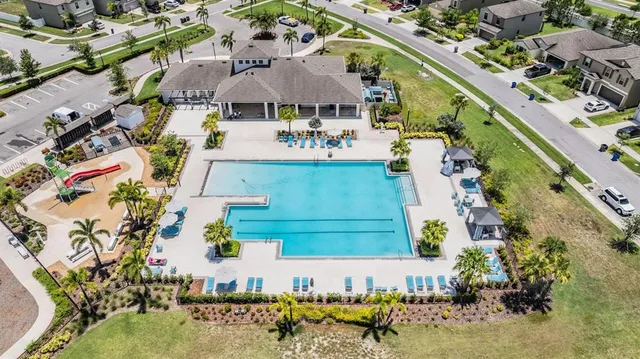 an aerial view of a house with a yard and a fountain