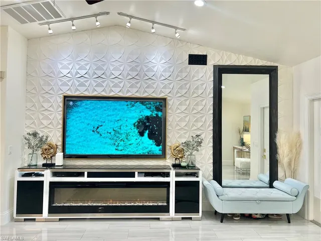 a living room with a flat screen tv and a fireplace