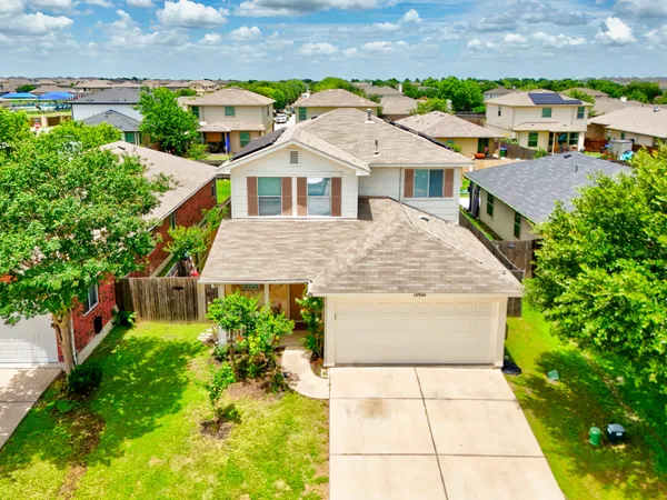 an aerial view of residential houses with yard