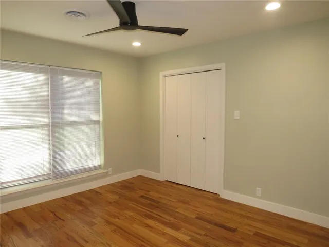 an empty room with cabinet and wooden floor