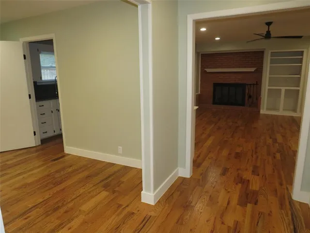 a view of an empty room and wooden floor