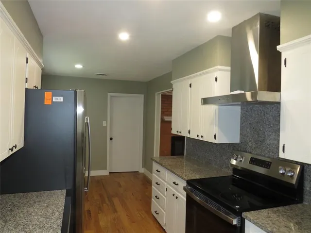 a kitchen with a sink and refrigerator