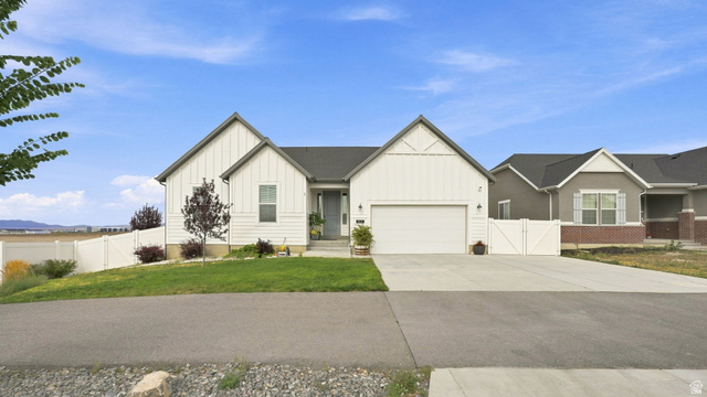 6017 North Sheps Road, Unit C211 Eagle Mountain, UT 84005 - Photo 1 of 25 White vertical siding exterior with contrasting dark gray trim