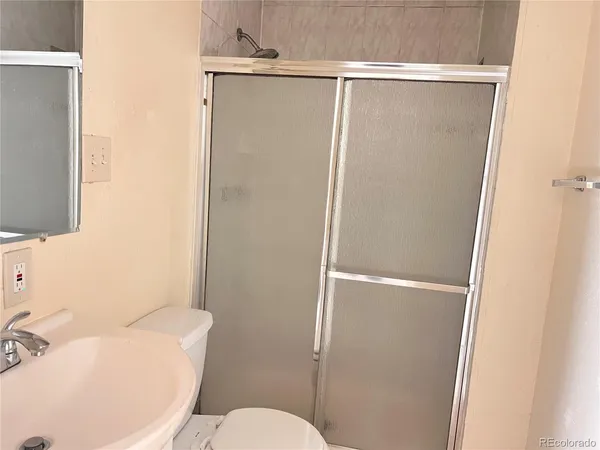 a white toilet sitting next to a bathroom sink