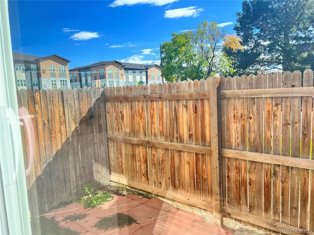 a view of a house with a wooden fence