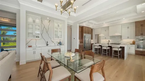 a dining room with furniture window and wooden floor