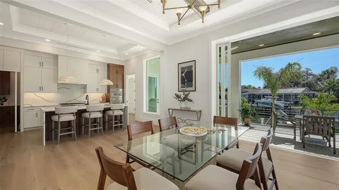 a kitchen with stainless steel appliances kitchen island granite countertop a refrigerator and cabinets