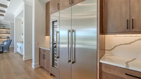a room with gym equipment and wooden floor