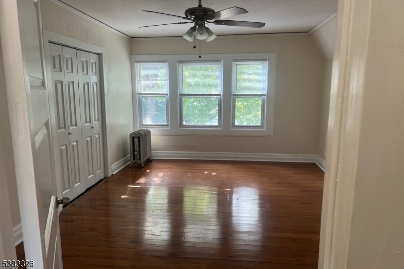 19 Spring Street Bloomfield, NJ 07003 - Photo 13 of 19 an empty room with wooden floor chandelier and windows