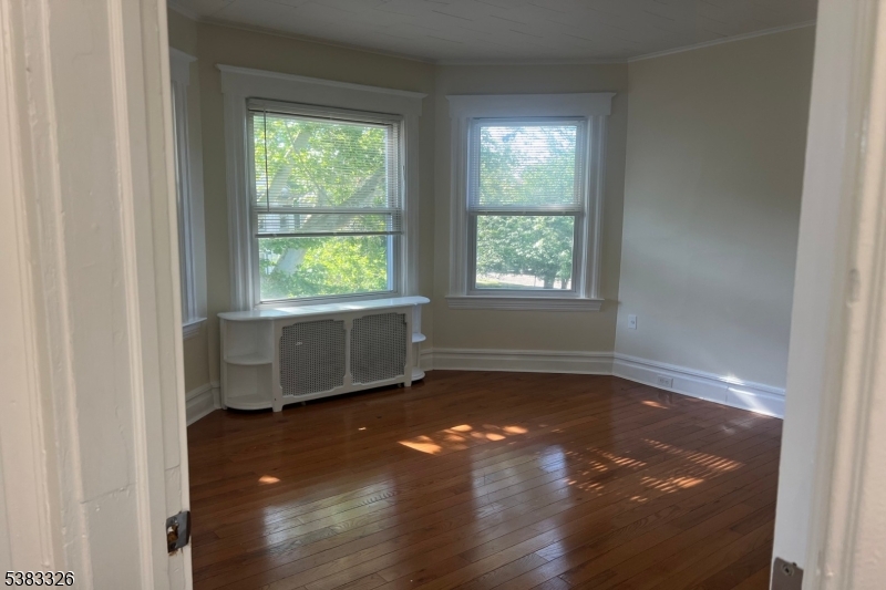 19 Spring Street Bloomfield, NJ 07003 - Photo 3 of 19 an empty room with wooden floor and windows