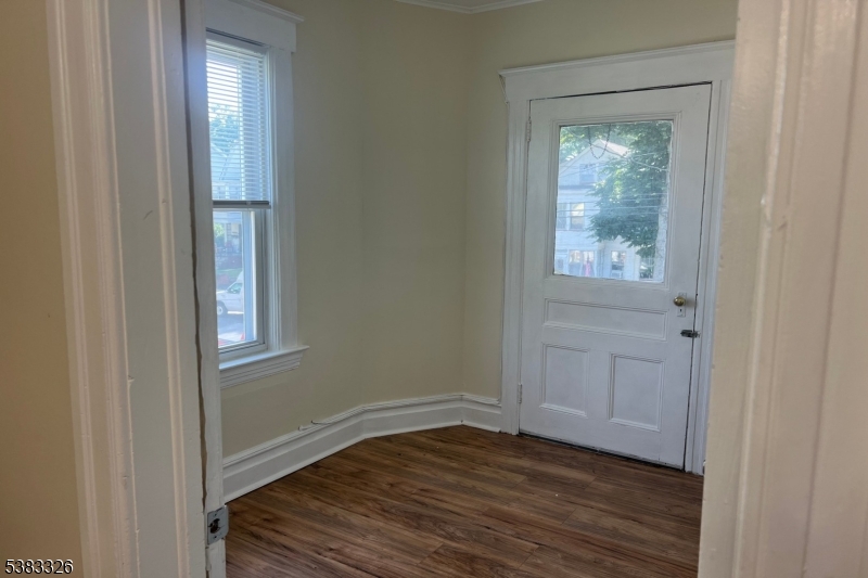 19 Spring Street Bloomfield, NJ 07003 - Photo 4 of 19 a view of an empty room with wooden floor and a window
