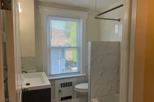 a kitchen with white cabinets and refrigerator