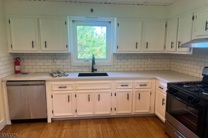 19 Spring Street Bloomfield, NJ 07003 - Photo 10 of 19 a kitchen with granite countertop white cabinets and a stove