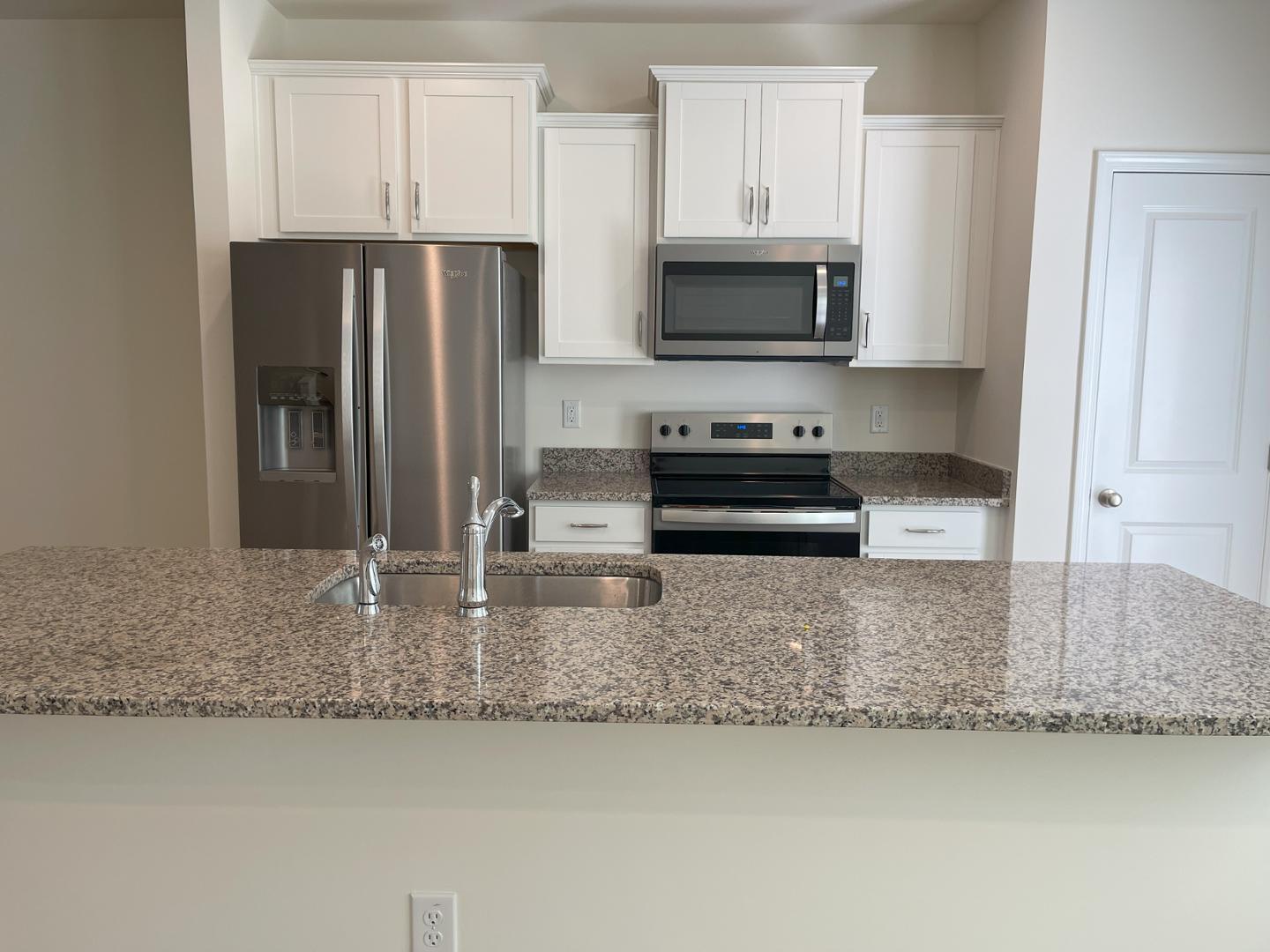 6306 Lady Eliza Lane Raleigh, NC 27610 - Photo 15 of 39 a kitchen with granite countertop a refrigerator a stove and a sink