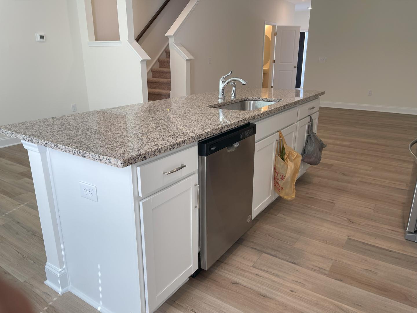 6306 Lady Eliza Lane Raleigh, NC 27610 - Photo 16 of 39 a kitchen with stainless steel appliances granite countertop a sink and wooden floor