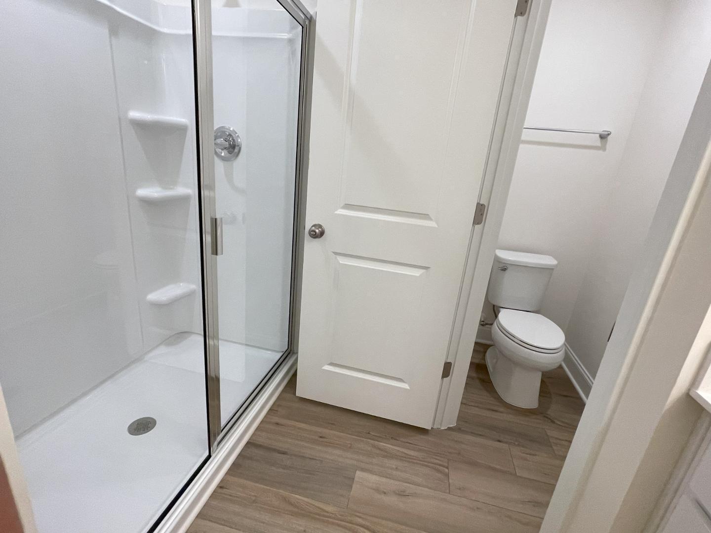 6306 Lady Eliza Lane Raleigh, NC 27610 - Photo 29 of 39 a bathroom with a glass door shower and toilet