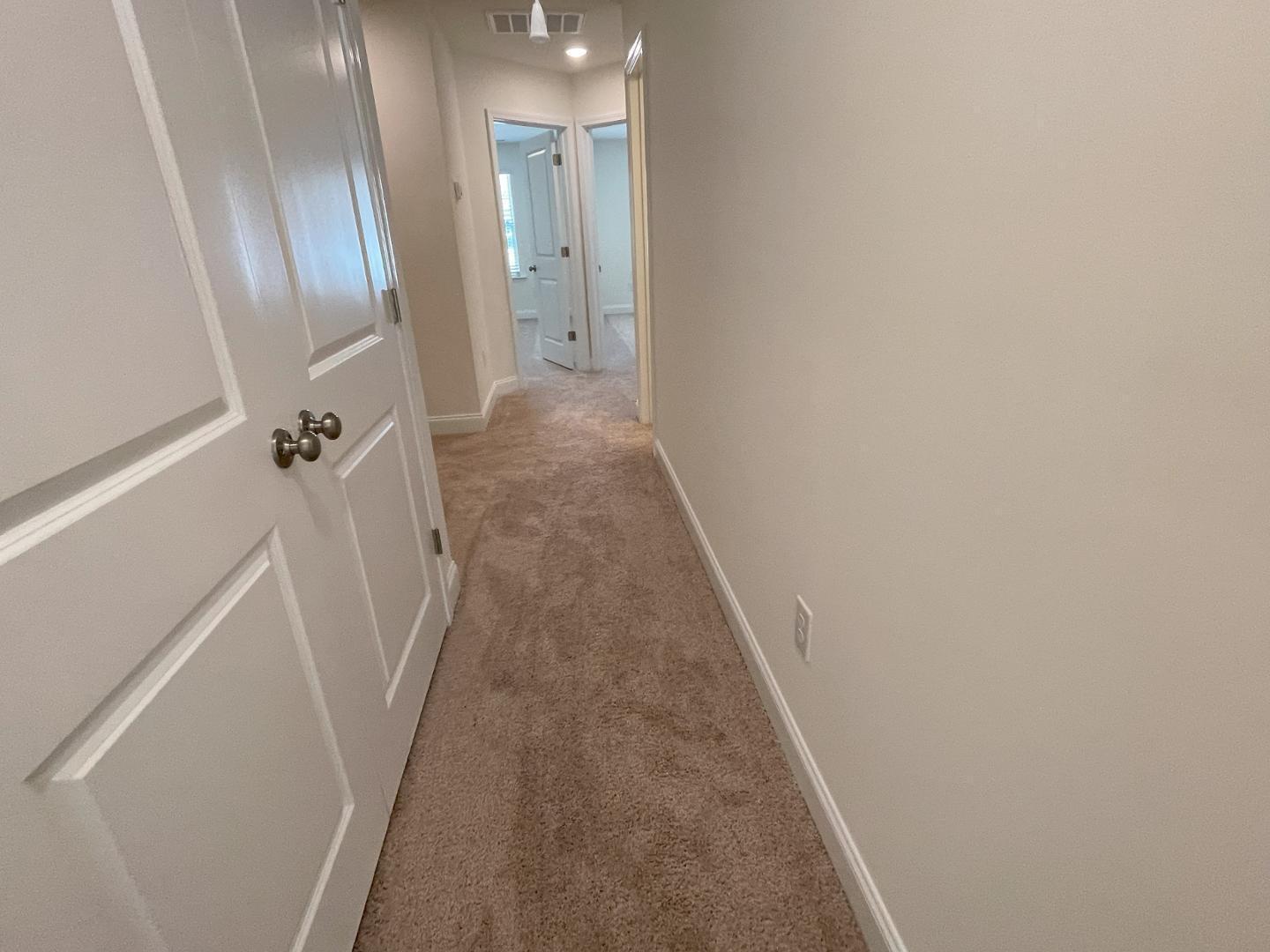 6306 Lady Eliza Lane Raleigh, NC 27610 - Photo 33 of 39 a view of a hallway with wooden floor and staircase