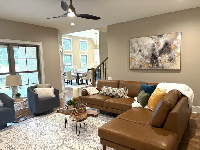 a dining room with wooden floor and a chandelier