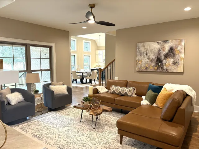 a living room with furniture and wooden floor