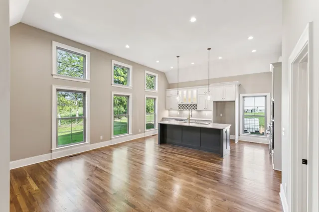 a large kitchen with a large window and stainless steel appliances
