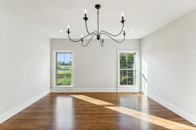a view of a room with wooden floor and window