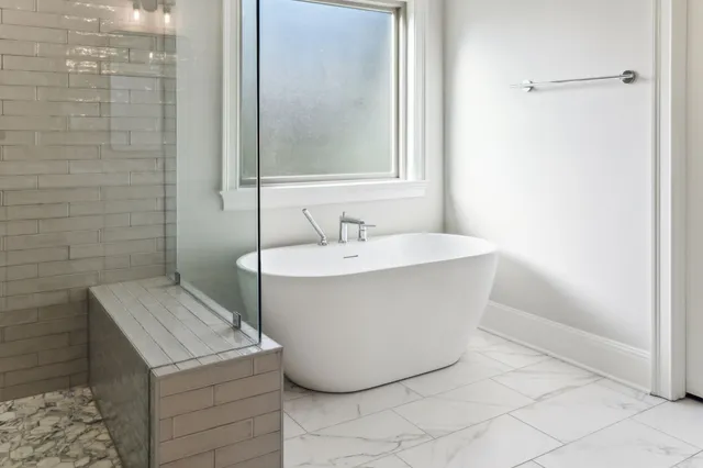 a bathroom with a glass shower door and a bathroom