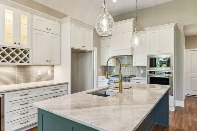 a front view of a house with a yard and trees