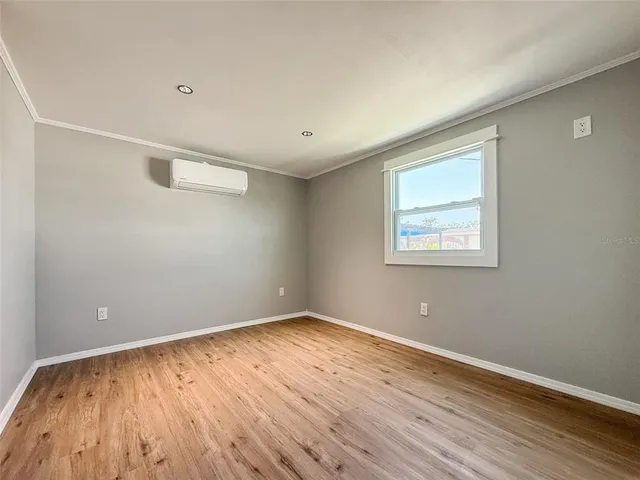 an empty room with wooden floor and closet