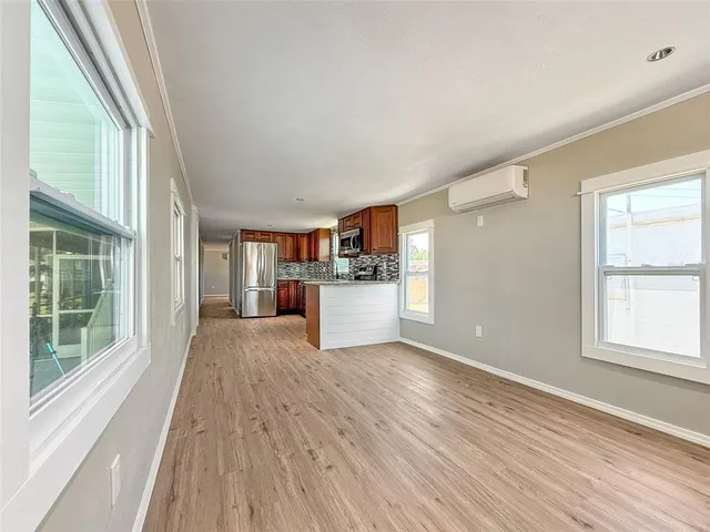 a view of a kitchen with wooden floor and windows