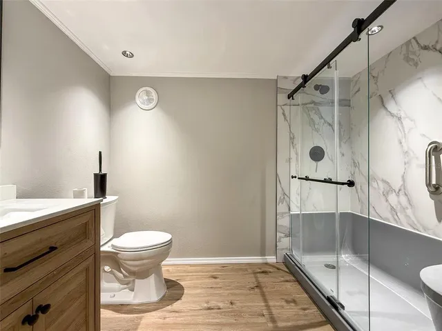 a bathroom with a shower toilet and sink