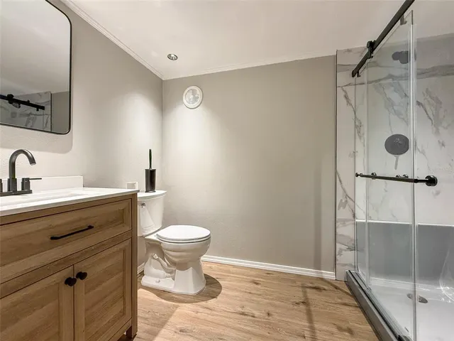 a bathroom with a toilet and a shower