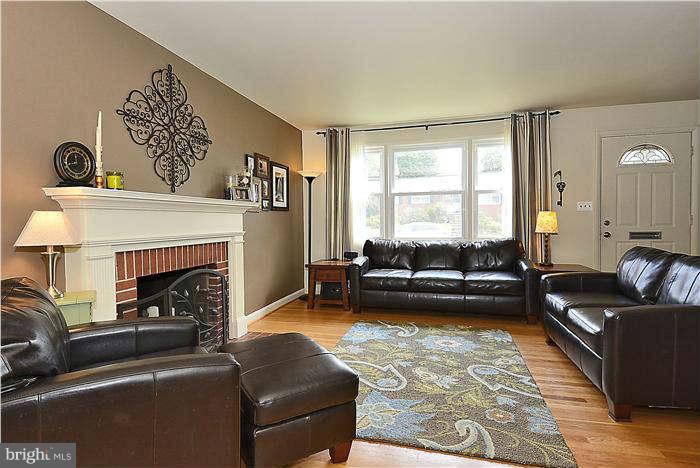 10204 Portland Road Silver Spring, MD 20901 - Photo 3 of 29 a living room with furniture and a fireplace