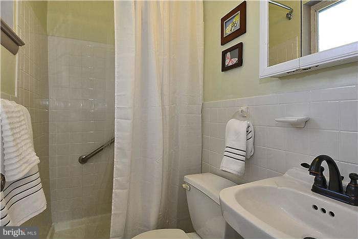 10204 Portland Road Silver Spring, MD 20901 - Photo 22 of 29 a bathroom with a sink a toilet and shower