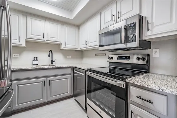 a kitchen with cabinets appliances and a sink