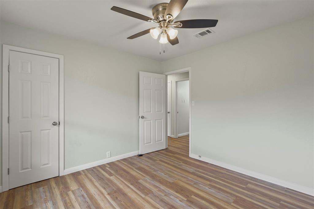 732 Bullock Street Denison, TX 75020 - Photo 14 of 29 a view of an empty room and window a ceiling fan