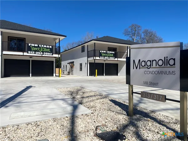 a front view of a building with sign board