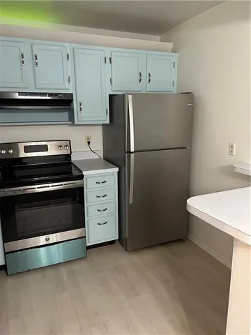 a kitchen with cabinets and a stove