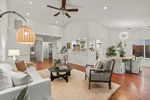 a view of a livingroom with a ceiling fan and window