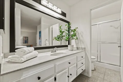 a bathroom with a toilet and a shower