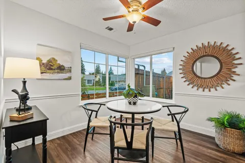 a kitchen with a sink and wooden floor