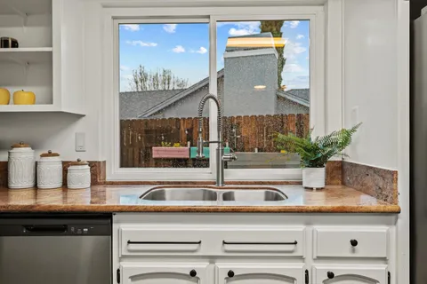 a kitchen with a table chairs stove and cabinets