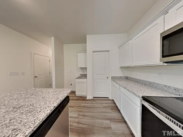 a kitchen with sink stove and microwave