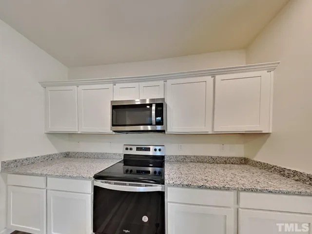 a kitchen with appliances cabinets and a counter top space
