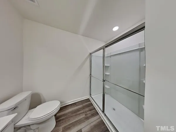 a bathroom with a toilet and a shower