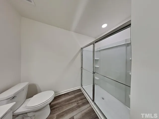 a bathroom with a toilet and a shower